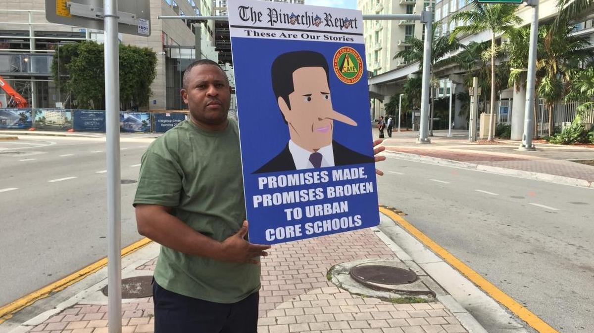 Milton Parris Jr. protests across the street from the InterContinental hotel in downtown Miami.