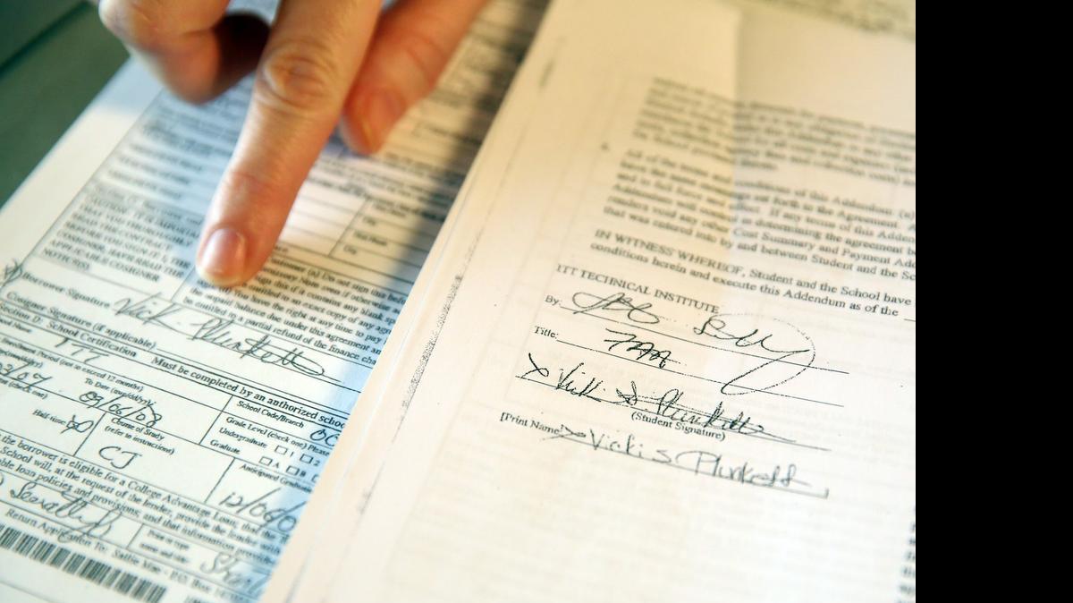 
Former ITT Tech student Vicki Plunkett points to her signature next to a federal loan application she says ITT Tech in Davie signed and submitted without her permission.
