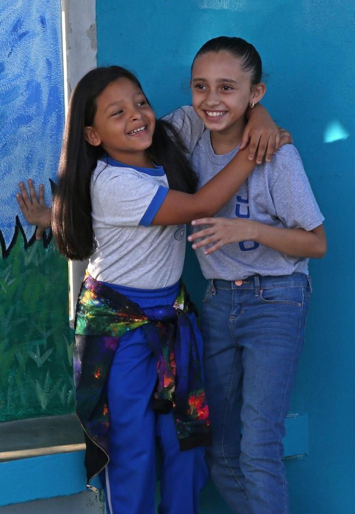 Fourth-grade student Annyely, left, hugs her classmate Krystal while talking before the start of classes at the Julio Selles Sola Elementary School in Rio Piedras, a neighborhood of San Juan, Puerto Rico on Tuesday, October 24, 2017.