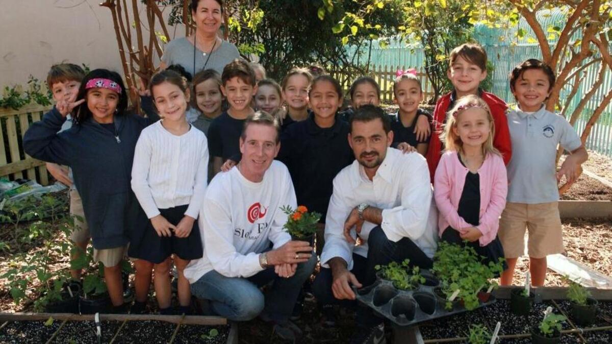From left in front, Sean Reichert of Slow Food Miami and Frederic Joulin with a group of students during an event to plant a garden at South Pointe Elementary in Miami Beach on Wednesday, Nov. 16, 2016.