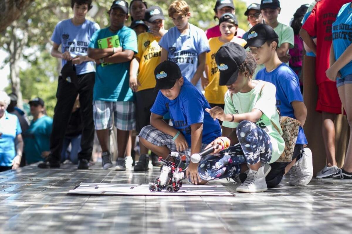 From left, Axel Barrado, Eddie Diaz and Ariyah Bell show off their robot Wall-E during a STEM Summer Camp presentation at Cutler Ridge Park on Saturday, Aug. 12, 2017.