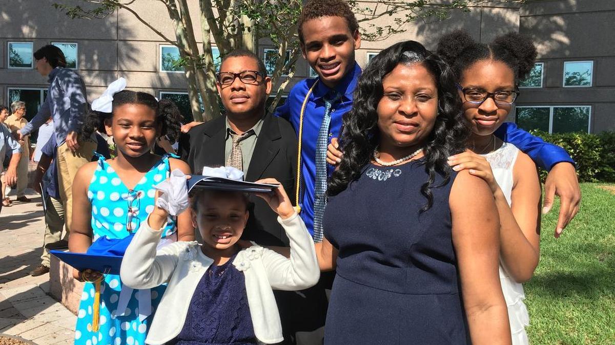 Minaldy Cadet, center, with his parents and three sisters on the day he graduated from St. Thomas Aquinas High School in Fort Lauderdale.