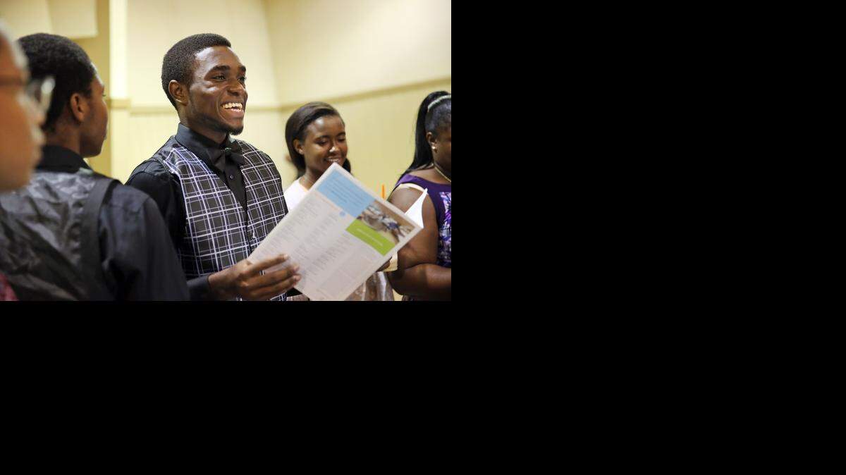 
Felix Lowentz, 17, a senior at Miami Central Senior High School is all smiles as he receives admissions information from Penn State during a college fair presented by the 100 Black Men of South Florida, Miami-Dade schools and a number of other businesses and groups. Universities from across the country were on-hand, some offering on-the-spot admissions to their schools.
