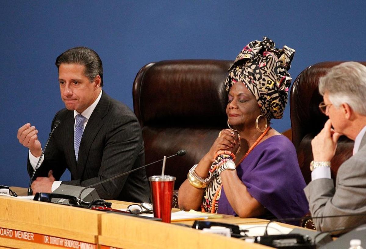 School Board Members Dr. Dorothy Bendross-Mindingall and Dr. Lawrence S. Feldman listen as Alberto Carvalho, superintendent of the Miami-Dade County Public Schools district, announces his decision to stay in Miami-Dade instead of going to New York City during a full house School Board meeting on Thursday, March 1, 2018.