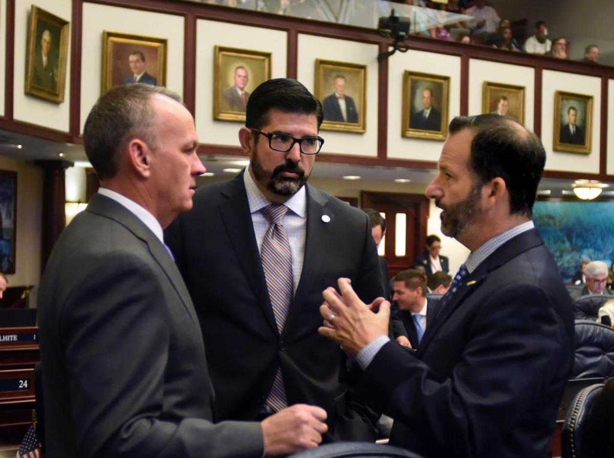 From the left, Speaker Richard Corcoran, R-Land O’Lakes, Rep. Manny Diaz Jr., R-Hialeah, and Rep. Michael Bileca, R-Miami, talk on the House floor March 22, 2017. Diaz and Bileca were lead negotiators in crafting the final version of HB 7069, which was a top legislative priority of Corcoran’s.