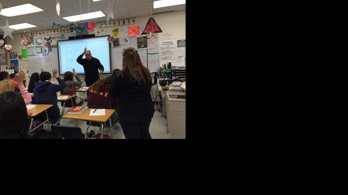 
John Paul Jebian, a sign language teacher at G. Holmes Braddock Senior High, teaches his high school students American Sign Language alongside Lisa Espineira, 37, a certified sign language interpreter.
