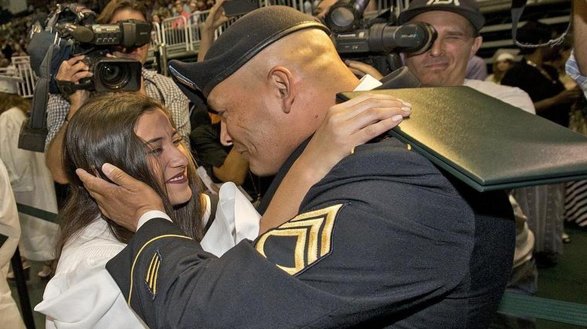 
U.S. Army Staff Sgt. Jose Garcia hugs his daughter Samantha after she received her diploma from Miami Killian Senior High School on Monday, June 1, 2015 at the BankUnited Center at the University of Miami. Garcia hadn’t seen his daughter in four years.
