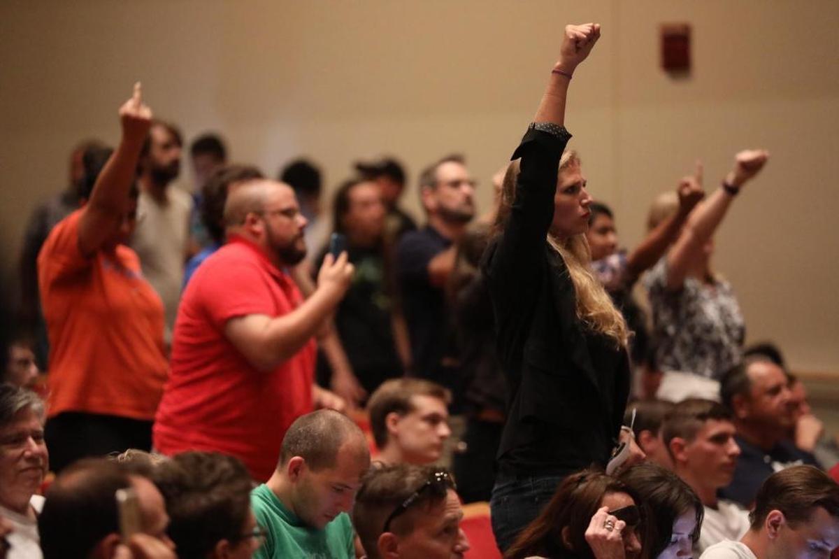 Persons in the crowd react to white nationalist Richard Spencer, who spoke Thursday, Oct. 19, 2017, at the Phillips Center at the University of Florida in Gainesville.