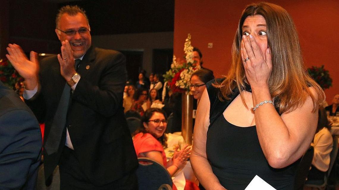 Molly Winters Diallo, of Alonzo and Tracy Mourning Senior High School, reacts after being chosen as the Francisco R. Walker Miami-Dade County Teacher of the Year 2019 while her principal, Chris Shinn, applauds at the Miami Airport and Convention Center in Miami, Florida.
