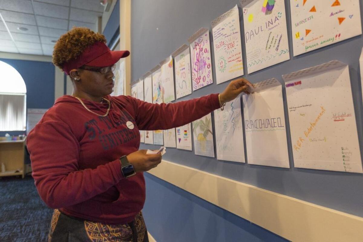 Segane Robinson, 22, places notes with positive reinforcements into envelopes during Camp MetroTown on Thursday, June 29, 2017, at St. Thomas University in Miami Gardens. Camp MetroTown, hosted by MCCJ, is a weeklong workshop for high school students to talk about issues they're confronting.