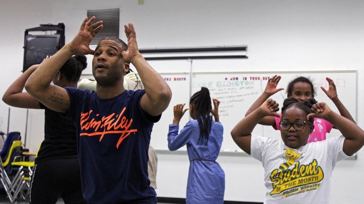 Alvin Ailey American Dance Theater instructor Winston Brown performs some of the dance from ‘Night Creature’ with students during a residency Feb. 16 at Phillis Wheatley Elementary School.