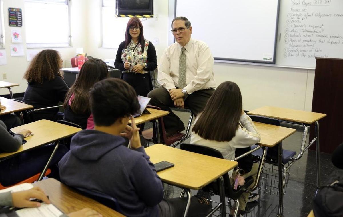 Joanyri Hernandez, 40, and Barbara Goleman Senior High Principal Joaquin Hernandez talk to Joanyri’s ninth-grade students about ‘The Odyssey’ during class on Tuesday, Nov. 28, 2017.