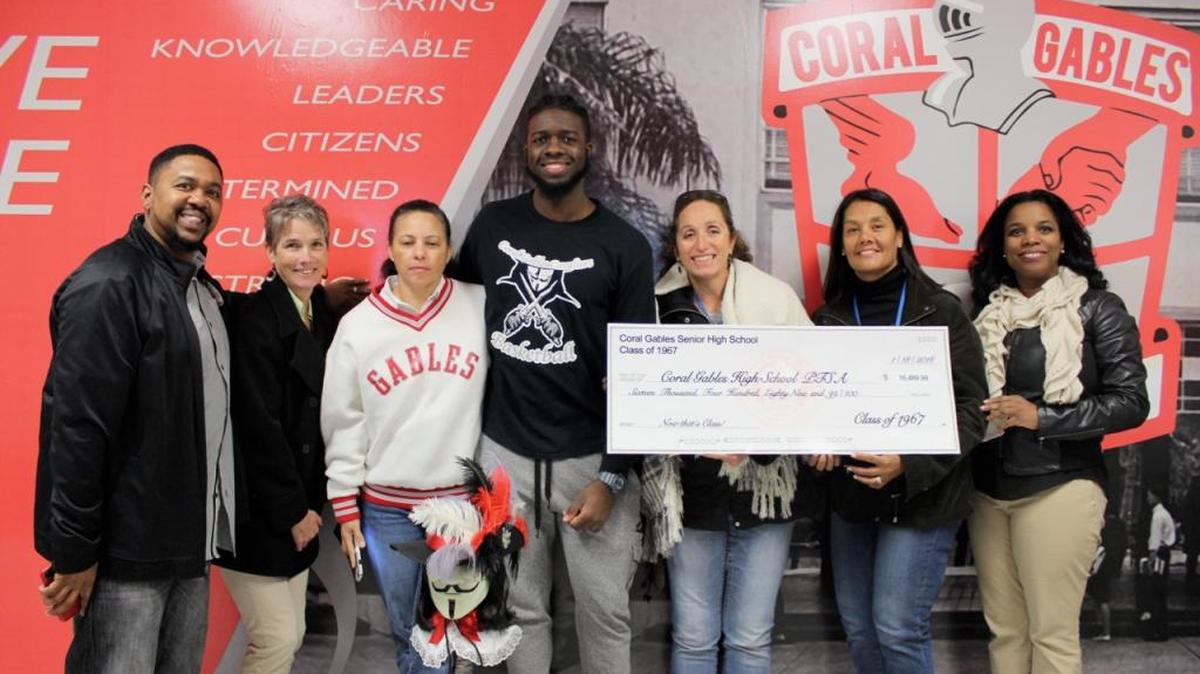 Alumni from Coral Gables High School, class of 1967, recently donated $16,000 to their alma mater for new television monitors and a digital scoring board. Pictured with Assistant Principal Joseph Evans and student-athlete Chris Brown are Parent Teacher Student Association members Carol Wilson, Lisa Senior, Jackie Kellogg, Marcela Tampied and Parmalyn Jacob.