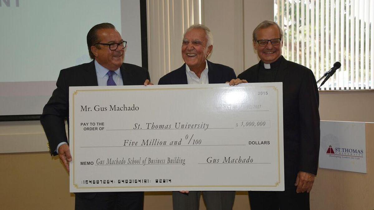 
St. Thomas University board chairman John Dooner, Gus Machado and the Rev. Monsignor Franklyn Casale (left to right) in a file photo from July 1, 2015. Machado and wife Lilliam gave a $5 million gift to the Catholic school in Miami Gardens to establish a business school in Machado’s name.