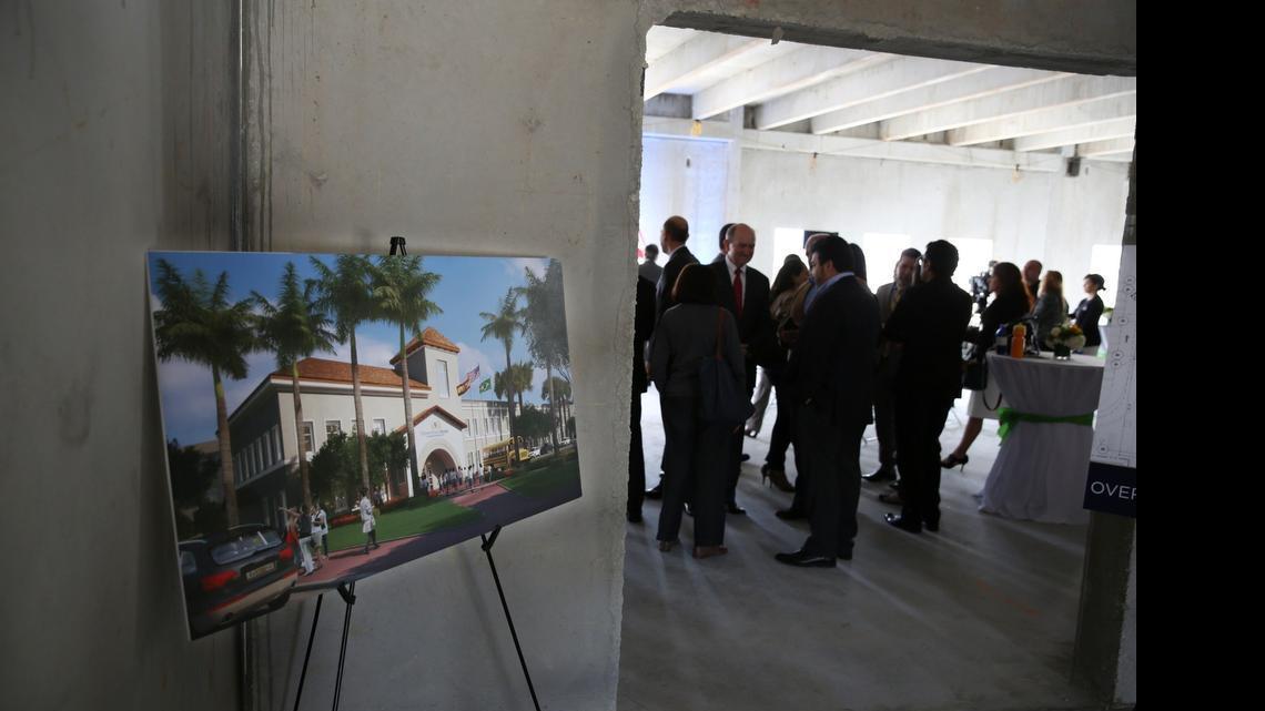 
A rendition of the new Downtown Doral Charter Elementary School on display during the “Topping Off” ceremony Thursday, Feb. 12, 2015. The elementary charter school began construction in April 2014 and is projected to open in the fall of 2015. The ranks of school teachers are thinning in public school classrooms as more students leave for charters. 

