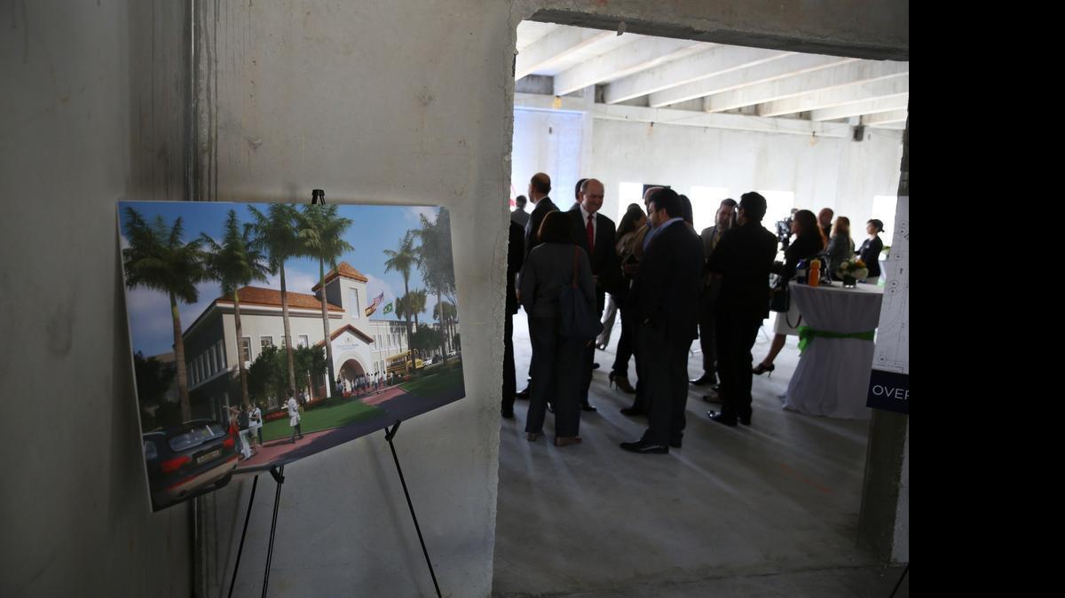 
A rendition of the new Downtown Doral Charter Elementary School on display during the “Topping Off” ceremony Thursday, Feb. 12, 2015. The elementary charter school began construction in April 2014 and is projected to open in the fall of 2015. The ranks of school teachers are thinning in public school classrooms as more students leave for charters. 

