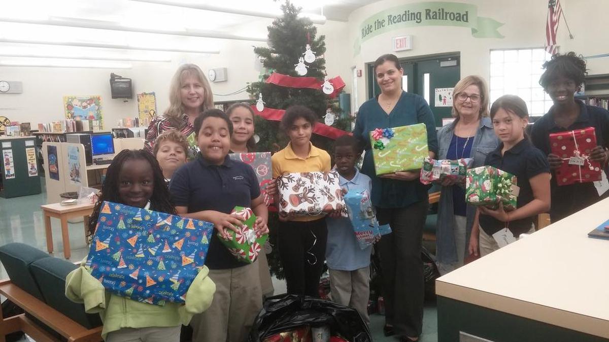Tykira Salter, Michael Kulikowski, Jordan Jimenez, Kayla Josephs, JuJu Wadi, Antoine Berry, Christina Diaz, Laura Rossano, Claudia Pozas, Gleniese Madison and Principal Deanna Dalby participate in Howard Drive Elementary School’s 16th Toy Drive.