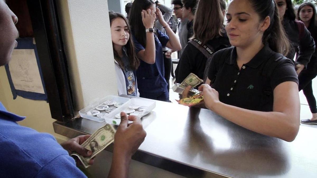 Danny Vaca-Figuereo, left, collects money from a customer at the Falcon Gift Shop. For young adults with special needs, finding a job after high school can be a challenge.