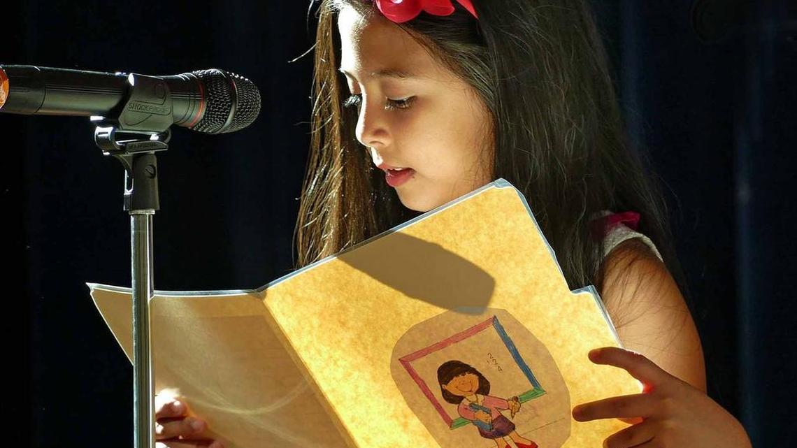 
Luciana Luquez reads in Spanish in the auditorium at Aventura Waterways K-8 School on May 14, 2015.

