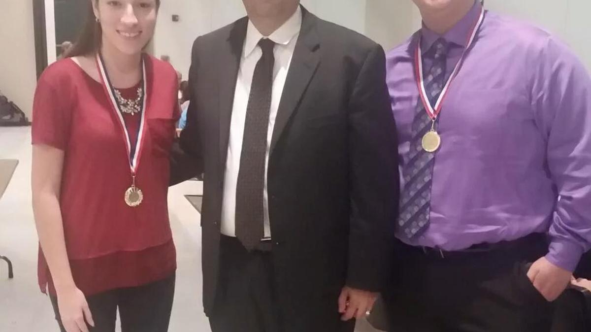 Maria Pita, left, and Andrew Garces, right, of the School for Advanced Studies (with Principal Omar Monteagudo, center) were honored during the recent Miami-Dade Schools District Seven Awards for their academic achievements and citizenship.
