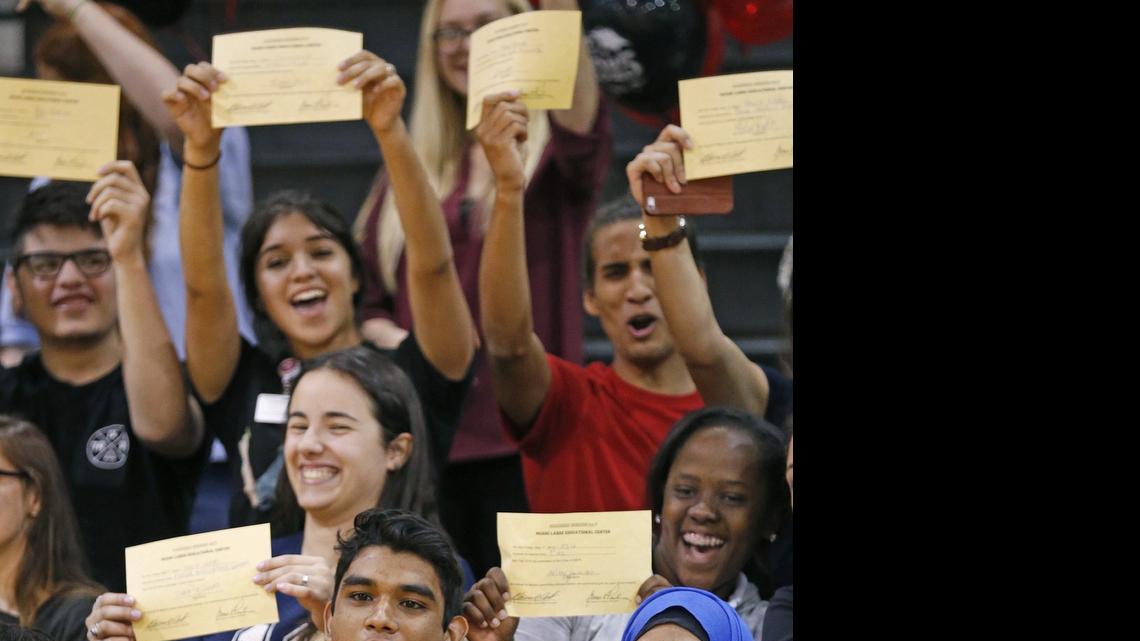 
Miami Lakes Educational Center senior Giancarlo Tejeda, who is undocumented, has raised enough money for the first year of college at the University of Florida. Here he celebrates with classmates after signing his acceptance to UF during ceremony at his high school on Friday, May 1, 2015
