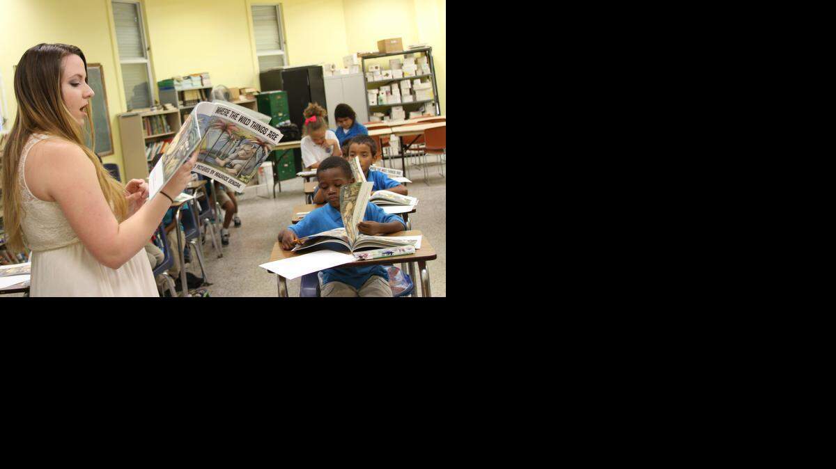 
Arts and literacy educator Bess Perry Garcia reads ‘Where the Wild Things Are’ to middle-school students inside Legion Park's after-school classroom.
