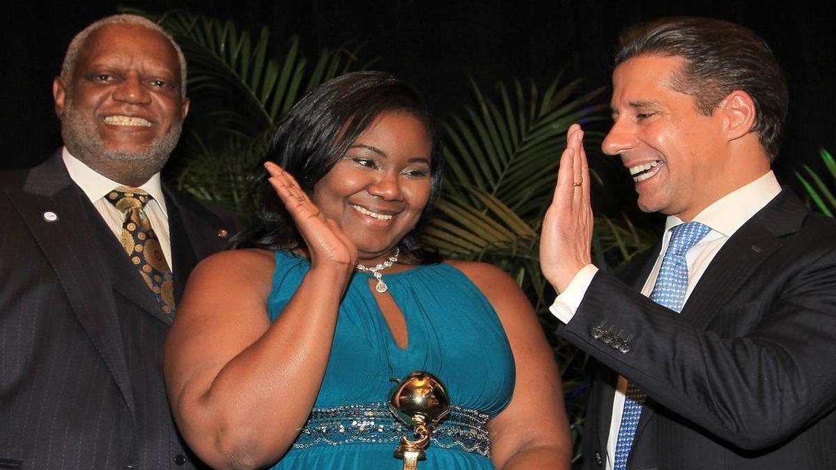 Miami-Dade Teacher of the Year Precious Tyesia Symonette, center, high-fives schools superintendent Alberto M. Carvalho as school board member Wilbert "Tee" Holloway looks on on Thursday, Jan. 28, 2016.