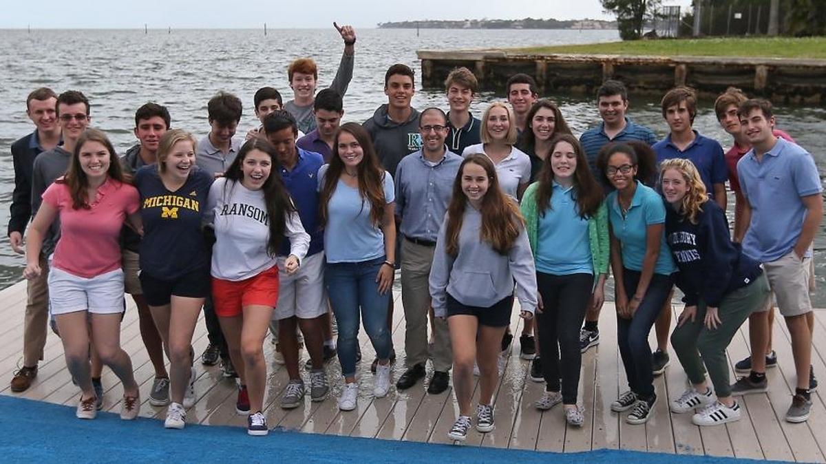 Gregory Cooper, center, stands with his Ransom Everglades students on Tuesday February 23, 2016. The students worked to create an online voter guide to provide objective, comprehensive information on Republican and Democratic candidates vying for their respective parties' nominations in the 2016 presidential election.