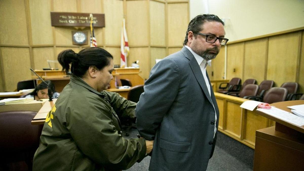 Dade Medical College owner Ernesto Perez is taken into custody after agreeing to a plea deal with prosecutors at Miami-Dade criminal courthouse on Tuesday, Nov. 3, 2015.
