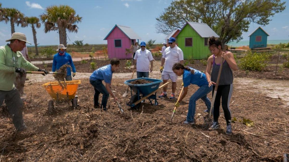 Miami Waterkeeper Junior Ambassador restoration project at Virginia Key Beach Park, where teenagers removed invasive plant species and picked up trash.