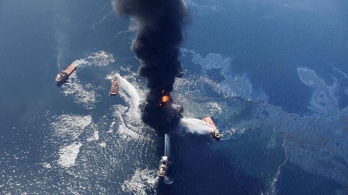 In this Wednesday, April 21, 2010 aerial file photo taken in the Gulf of Mexico more than 50 miles southeast of Venice on Louisiana’s tip, an oil slick is seen as the Deepwater Horizon oil rig burns.