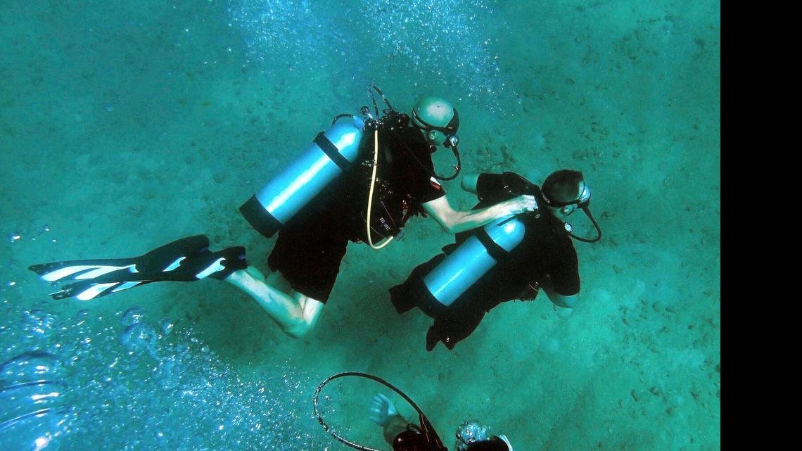 
Jim Elliott, left, president of DIVEHEART, buddies with Joseph Deslauriers, 36, wounded Air Force retired vet. They dive off the Fort Lauderdale coast checking on coral with Nova Southeastern University College of Natural Sciences and Oceanography and DiveBar, Wednesday June 24, 2015. Deslauriers lost one arm and both legs in a land mine explosion.
