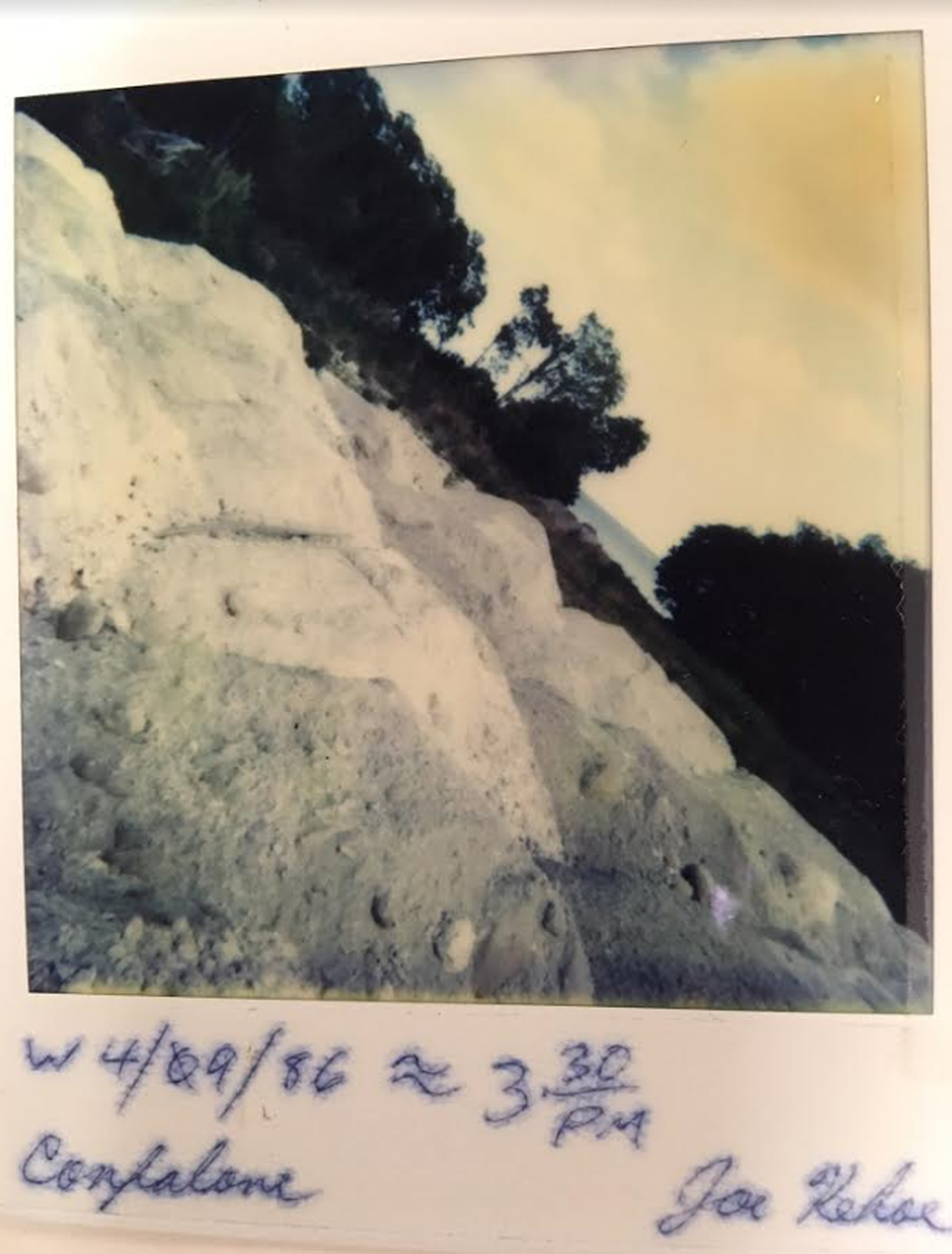 A 1986 Polaroid shot three years after former owner James Confalone purchased the property shows piles of fill trucked in to fill wetlands.