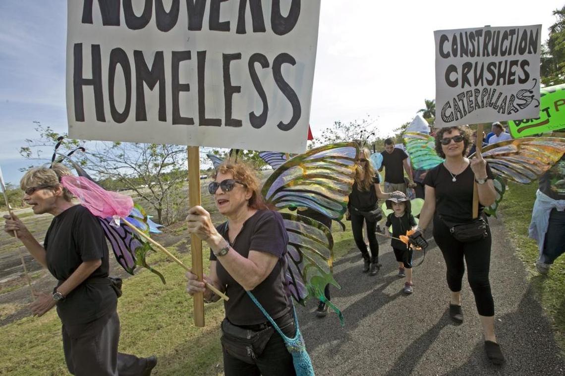 Protesters march as the Miami Rocklands Preservation Coalition and other groups rally to protest a Walmart and an amusement park planned for protected pine rockland near Zoo Miami in January 2015.
