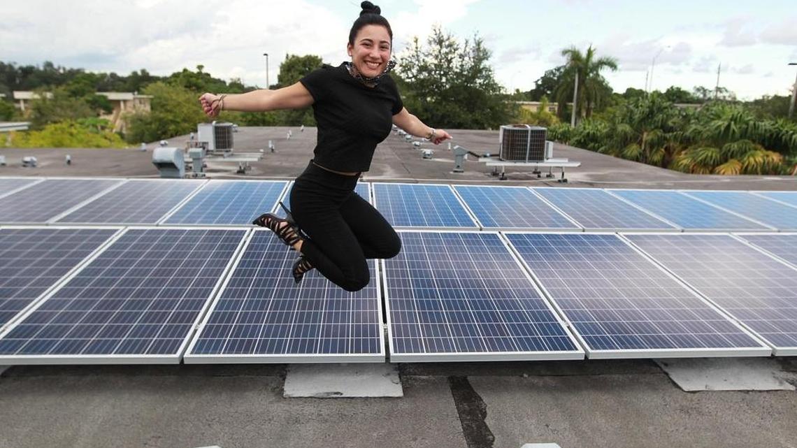 
Florida International University student Chloe Castro jumps above the high-tech solar panels on Camillus House Friday, Sept. 25, 2015, in Miami. The panels, part of an $80,000 energy makeover, evolved from a class project by Castro, a FIU communication arts graduate. Her assignment: design a project to translate philanthropy into everyday life, then persuade 27 classmates that hers was better than theirs.
