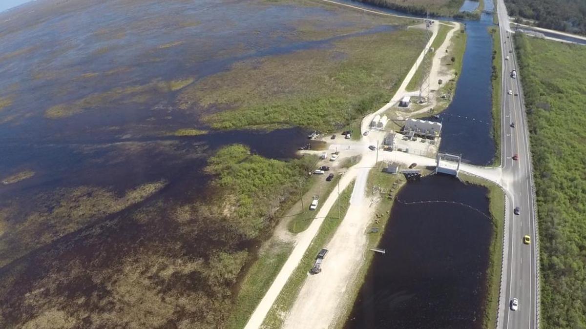 Water managers will continue pumping about 1.6 billion gallons of water a day into Everglades National Park to lower levels in a vast conservation area north of the Tamiami Trail, pictured here, that remains about a foot too high.