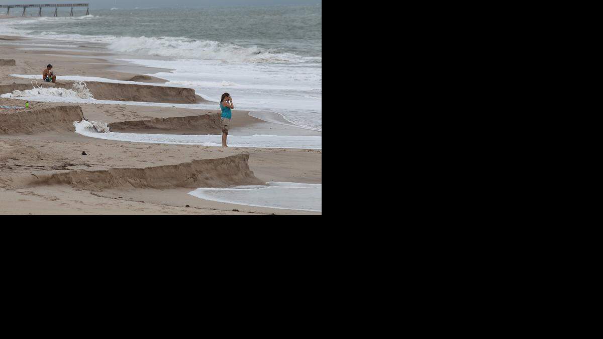 
Beach goers in August 2010 watch five foot waves from Hurricane Danielle pound the coast off Vero Beach, causing extensive beach eronsion.
