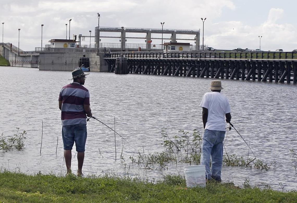 Two fisherman at Port Mayaka Lock on Lake Okeechobe. Lake Okeechobee has been hovering above 17 feet for more than a month despite regular releases, raising concerns over the lake's aging dike and devastating habitat along the rim.