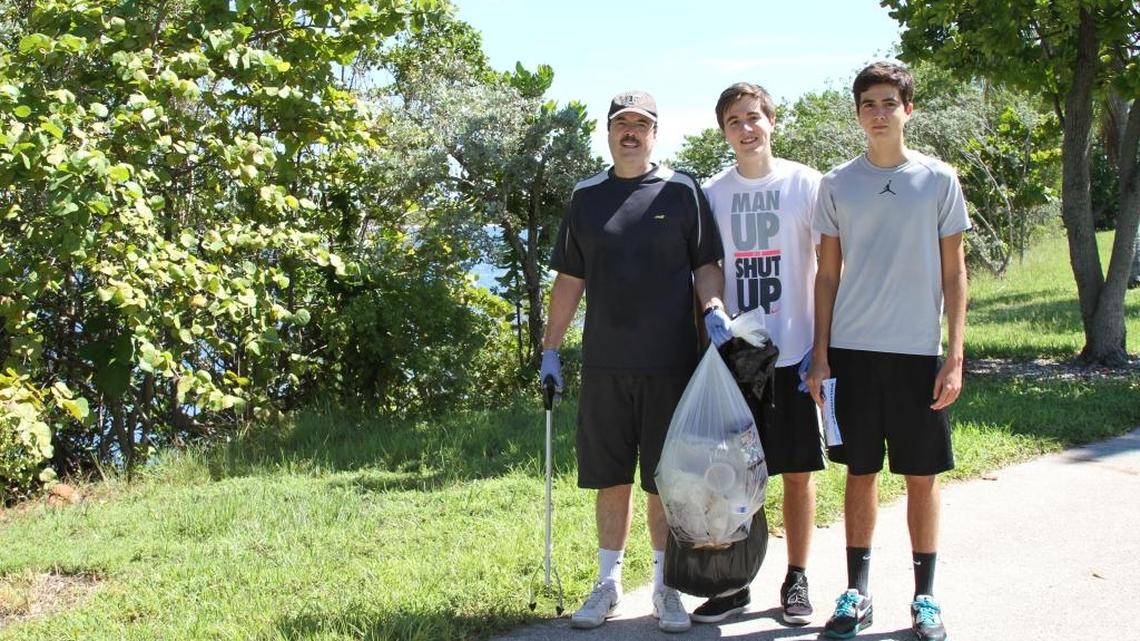 
Luis Garcia picked up trash from Florida International University's Biscayne Bay campus with his two sons, Sebastian Garcia, middle, and Sergio Garcia, on Saturday, during the Miami-Dade Coastal Cleanup, part of International Coastal Cleanup Day. ‘We need to take care of the environment, for us and for our future generations,’ Luis said.
