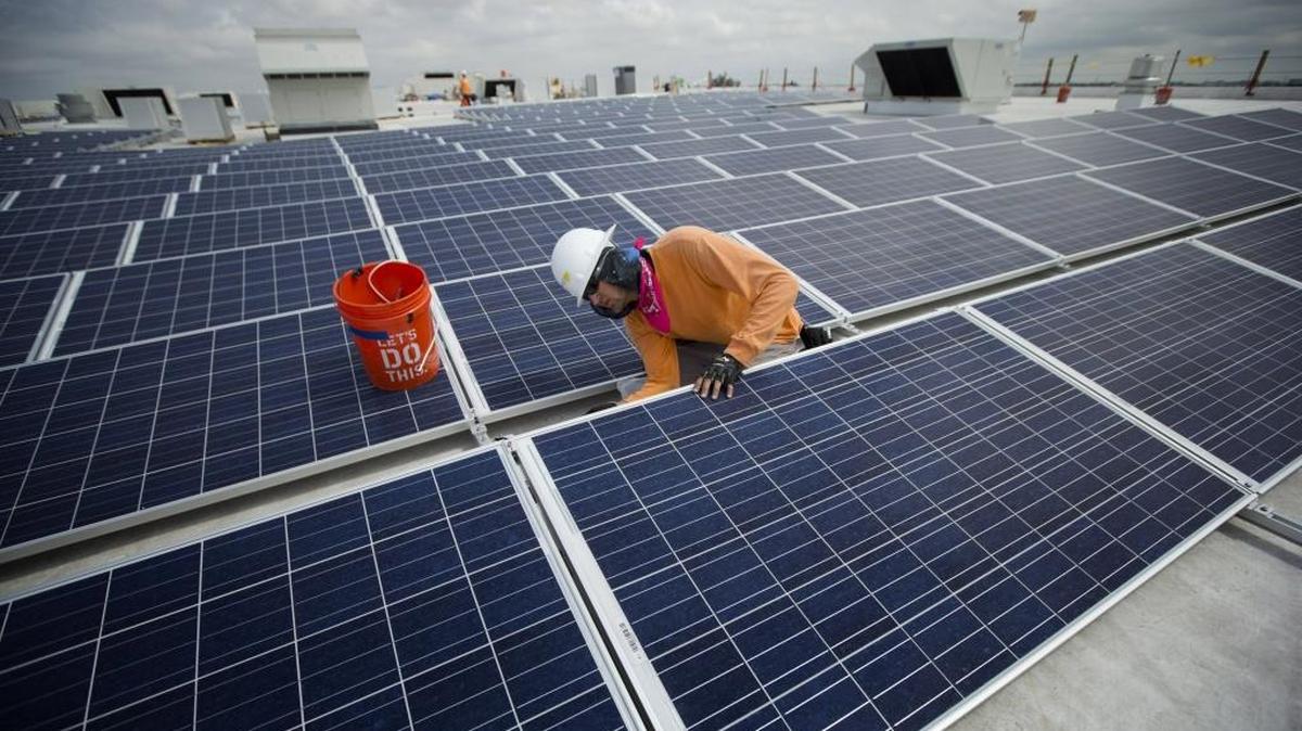 Neil Black works on the installation of South Floridaâs largest solar panel array atop the future IKEA store in Miami, Wednesday, April 16, 2014.