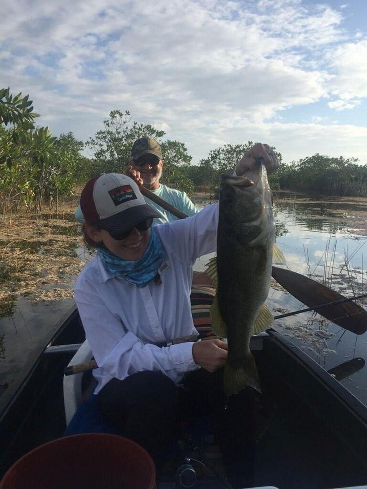 Quinn Donnely, from Key Largo, holds a large mouth bass he caught fishing with Capt. Vinny on Christmas Day, Dec. 25, 2017, on ultra light tackle from a canoe on a pond deep within the Everglades National Park.