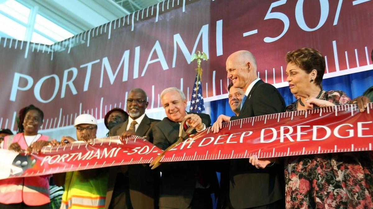 
Miami-Dade County Mayor Carlos Gimenez, with scissors, marks the completion of the Deep Dredge project at PortMiami with Florida Lt. Gov. Carlos Lopez-Cantera, Gov. Rick Scott and Miami-Dade Commissioner Rebeca Sosa and other officials on Friday.
