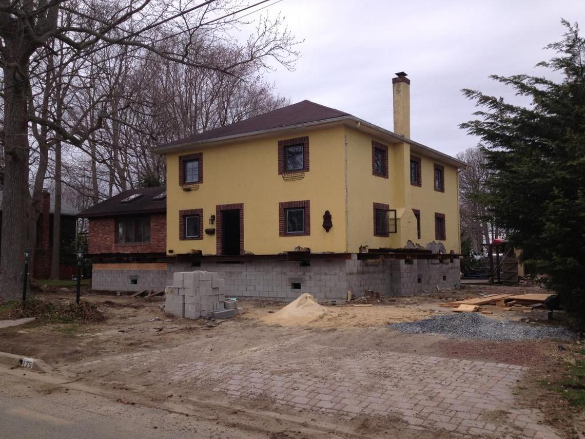 A two-story home in New Jersey elevated by Roderick Scott’s company in 90 days. The process cost $200,000, with $60,000 of the cost coming from a flood insurance grant and the state’s FEMA payout.