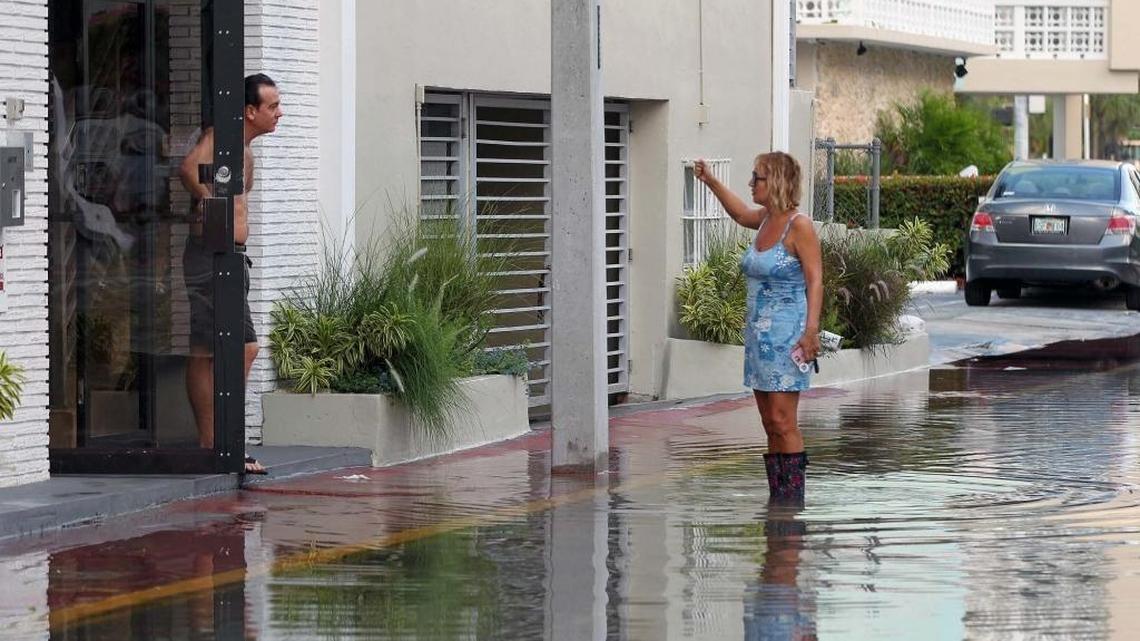 Valerie Navarrete has her waterproof boots on this morning as she speaks to her neighbor in the 1400 block of Lincoln Road Court. Every year, King's Tide floods certain areas of Miami Beach.
