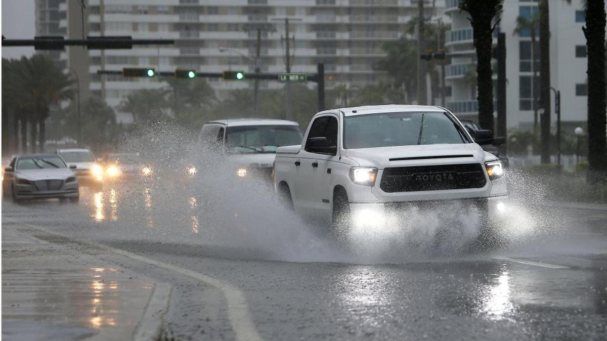 Cars goes through the flooded streets at South Ocean Drive on Tuesday, June 6, 2017, in Hallandale Beach.