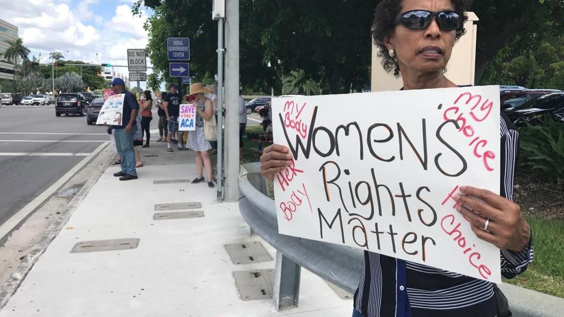 Rose Williams, 59, holds up a sign along 36th Street in Doral near Sen. Marco Rubio’s office on July 18, 2017. Williams protested the Senate’s replacement bill, which effectively failed after two more senators announced their opposition June 17.