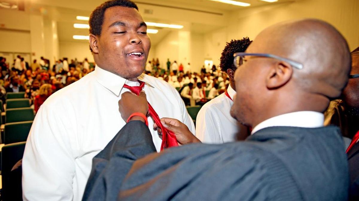 Eloy Beaucejow 17, has his tie tightened by Judge Rodney Smith at the 5000 Role Models of Excellence Tie Tying Ceremony at Central High School, on Tuesday, Oct. 18, 2016. These men commit to guiding these boys on a carefully chartered path to manhood by aiding in monthly meetings, attending field trips, completing service projects and continued ongoing mentoring.