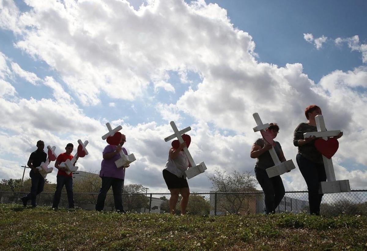Volunteers carried crosses to be placed in front of Marjory Stoneman Douglas High School on Feb. 18 in honor of the victims of the mass shooting there.
