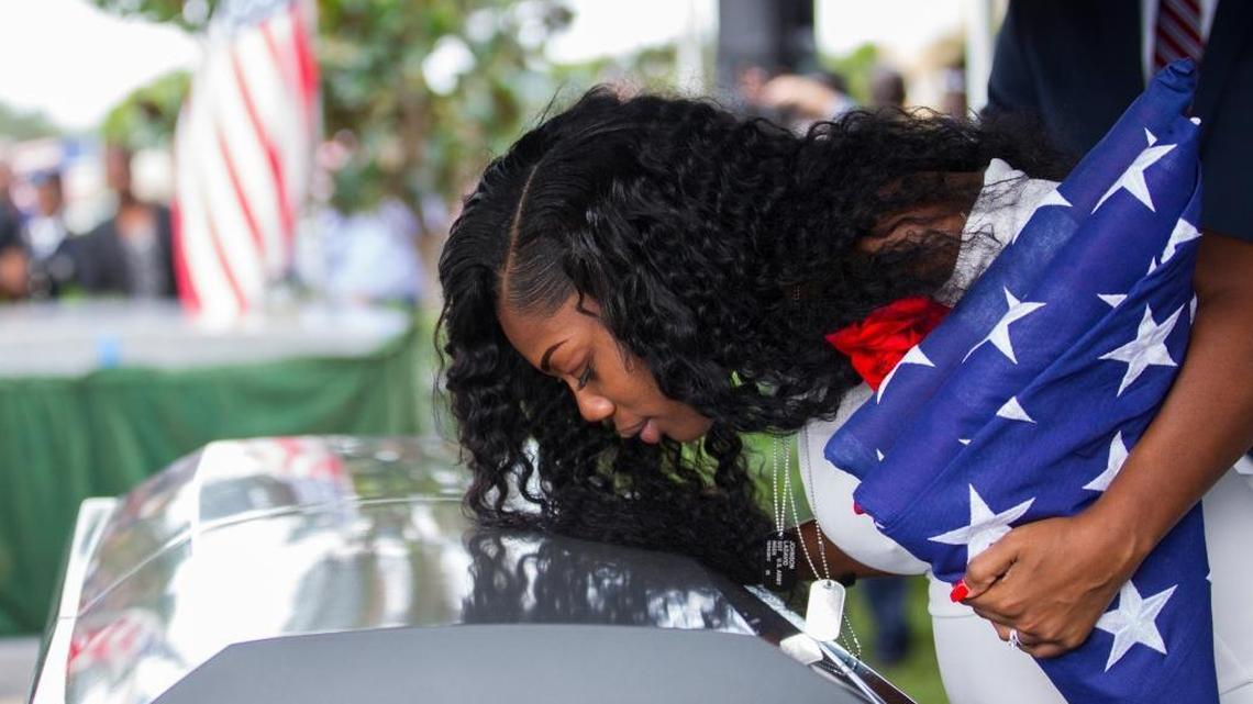 Myeshia Johnson kisses the casket of her husband, Sgt. La David Johnson, during his burial service at Fred Hunter's Hollywood Memorial Gardens in Hollywood, Florida on Saturday, Oct. 21, 2017.