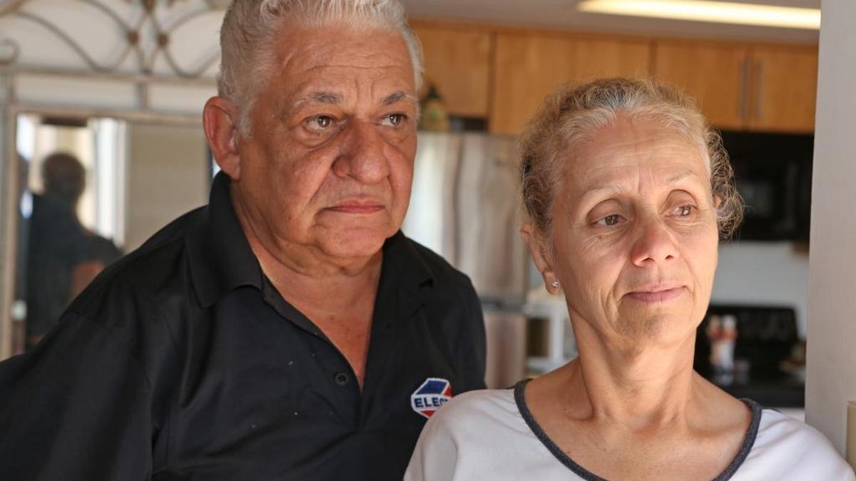Pedro Ramos and his wife Eugenia Ramos say they lost $25,000 in what police say was a Ponzi scheme involving tickets to Cuba. They are pictured in their Miami Lakes home.